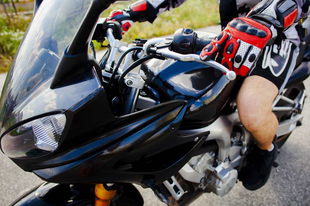 Motocyklista w pełnym stroju ochronnym z kurtką i kaskiem